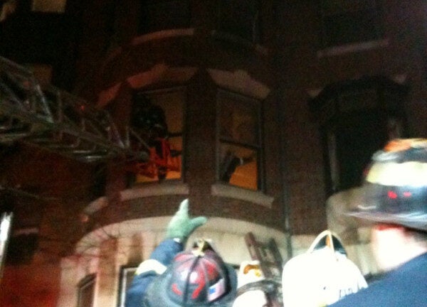 Boston firefighters use ladders to rescue two people from burning Back ...
