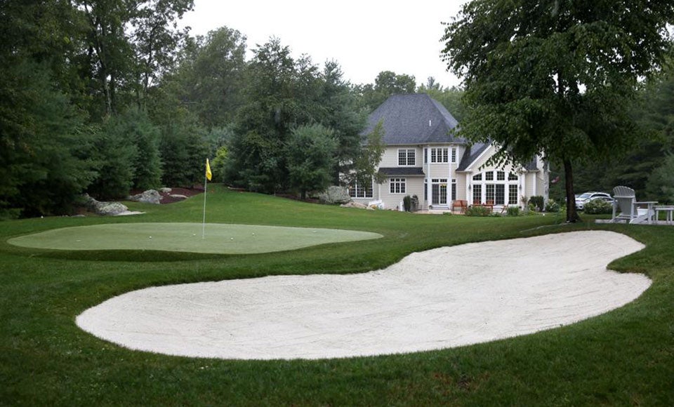 The backyard of this Hopkinton Colonial is modeled after a famous golf