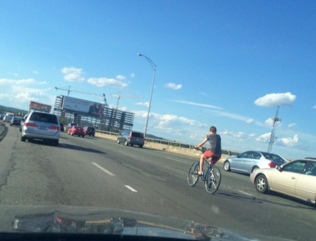 man-rides-bicycle-on-interstate-during-boston-rush-hour