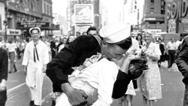 Two young men kissing, in the middle of tokio, night