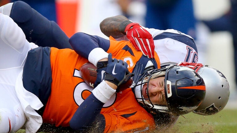 Denver Broncos Peyton Manning throws against the New England Patriots  during the AFC Championship game at Sport Authority Field at Mile High in  Denver on January 24, 2016. Denver advances to Super