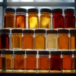 Sample bottles containing various grades of maple syrup are displayed at the Merrifield Farm and Sugar Shack, Wednesday, March 9, 2016, in Gorham, Maine. Maple Syrup Sunday will be celebrated at sugar shacks around the state on March 27. This year syrup runs started early due to warm weather and producers are concerned about how much syrup will be left on the big day. (AP Photo/Robert F. Bukaty)