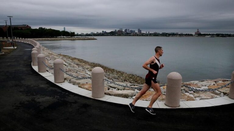 A runner used the newly opened section of the Harborwalk at UMass Boston on July 18.