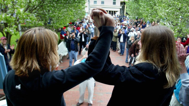 GAY MARRIAGE REMOTE TRANSMISSION -- REMOTE TRANSMISSION--- Provincetown, MA-5/17/04-Truro residents Eileen Counihan(cq),48, & her partner of 25 years, Erin Golden(cq),45, acknowledge wellwishers outside Provincetown Town Hall after obtaining their marriage license. Said Golden, 'one small kiss for us, one giant kiss for mankind.' Both women, who have known each other since they were 13, own a Commerecial Street gift store & have a 10 year old son,Jake. Both plan a quiet ceremony at 3pm on the beach behind their shop, with a few friends & family in attendance.outtake