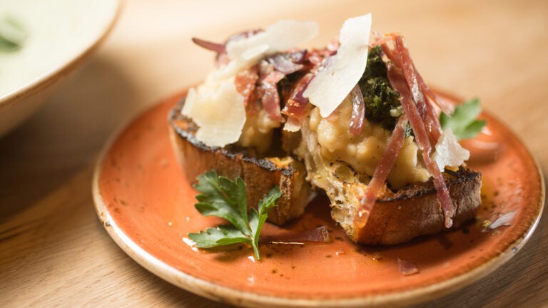 Soppressata and white bean bruschetta with grilled red onion fennel pollen and pecorino.