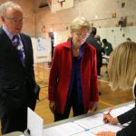 CAMBRIDGE MA - 11/08/2016: Checking in to vote L-R Bruce Mann with his wife US Sen Elizabeth Warren at Ward 8 in the Graham and Parks School in Cambridge. The 2016 presidential election, voter turnout at polling places (David L Ryan/Globe Staff Photo) SECTION: METRO TOPIC 09turnout
