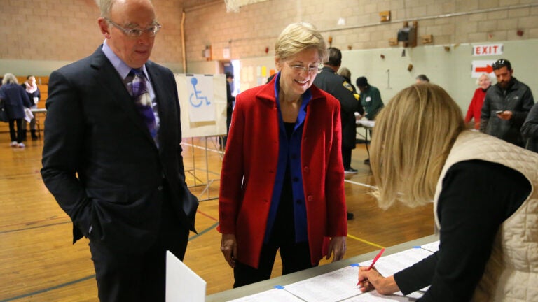 CAMBRIDGE MA - 11/08/2016: Checking in to vote L-R Bruce Mann with his wife US Sen Elizabeth Warren at Ward 8 in the Graham and Parks School in Cambridge. The 2016 presidential election, voter turnout at polling places (David L Ryan/Globe Staff Photo) SECTION: METRO TOPIC 09turnout