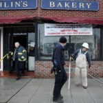 31webelmont - A construction worker clears the scene of the oven explosion at Ohlin's Bakery in Belmont. (Craig F. Walker/Globe Staff)