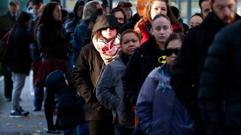 People line up to vote in the East Boston neighborhood of Boston, Tuesday, Nov. 8, 2016. (AP Photo/Michael Dwyer)