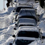A man shoveled his car out of the snow on M Street in South Boston.