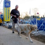 A police officer and a working dog perform a security sweep at the starting line of the Boston Marathon in Hopkinton, April 17, 2017.