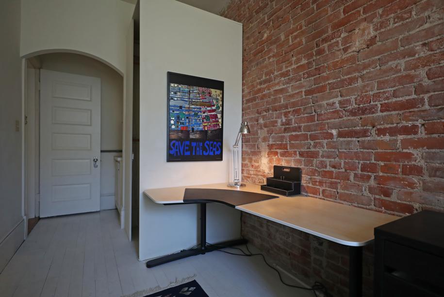 Two-bedroom condo with exposed brick overlooks Back Bay Fens