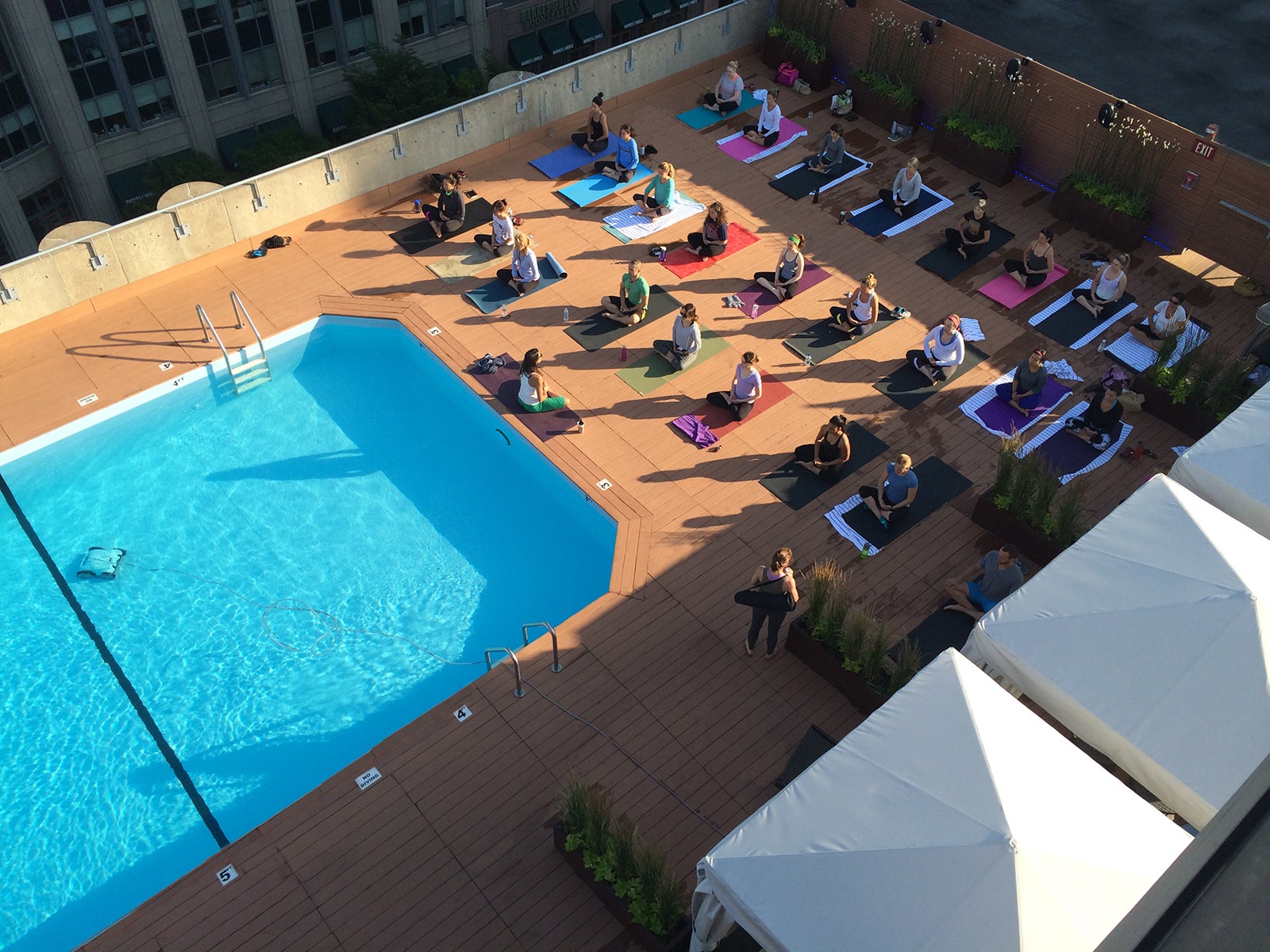 This rooftop yoga class overlooks the city and a pool