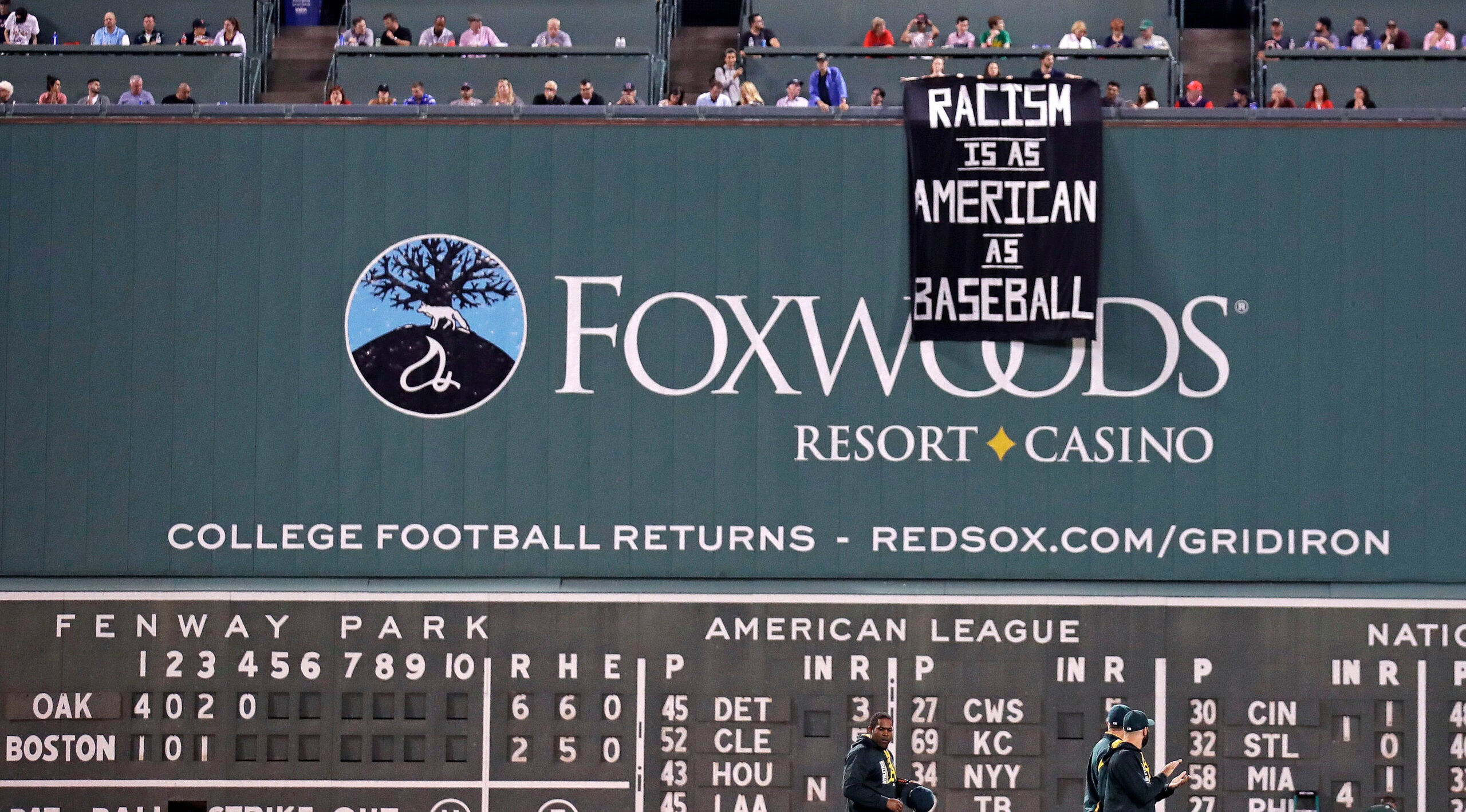 Fans drape 'Racism is as American as baseball' sign over Green Monster