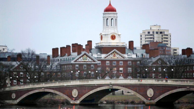 Rowers paddle on Charles past Harvard