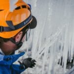 An ice artisan harvests icicles.
