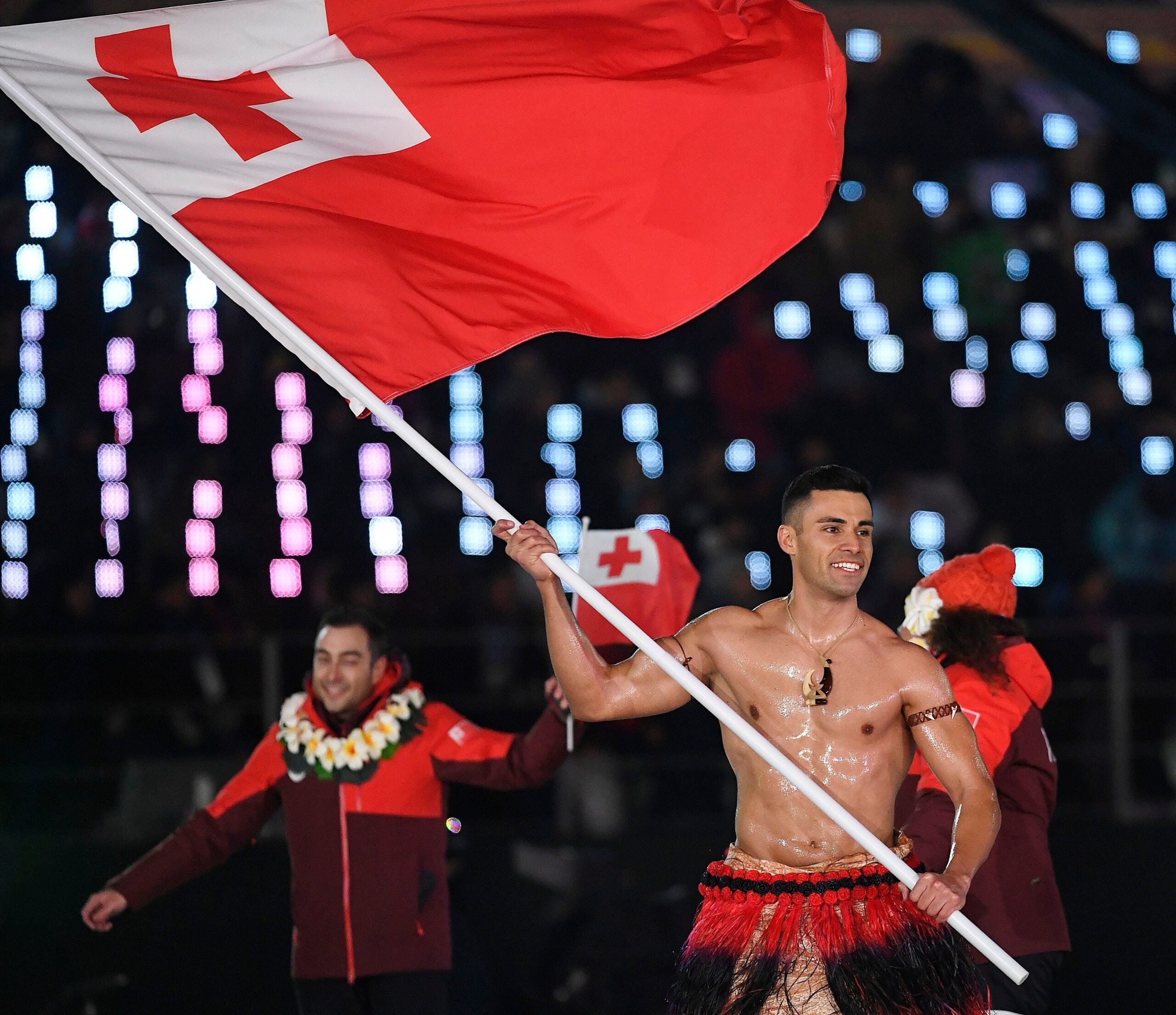 Here’s why Tonga’s barechested flag bearer is back at the Olympics