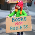 young boy march for our lives sign