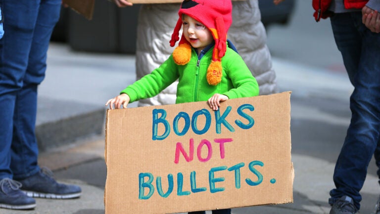 young boy march for our lives sign