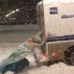 Man dressed as Elsa pushes police wagon