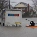 Daniel Cunningham kayaks in flood in Quincy, March 2018.