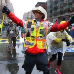 Carlos Arendondo running for his son Alex, who died, crosses the finish line.
