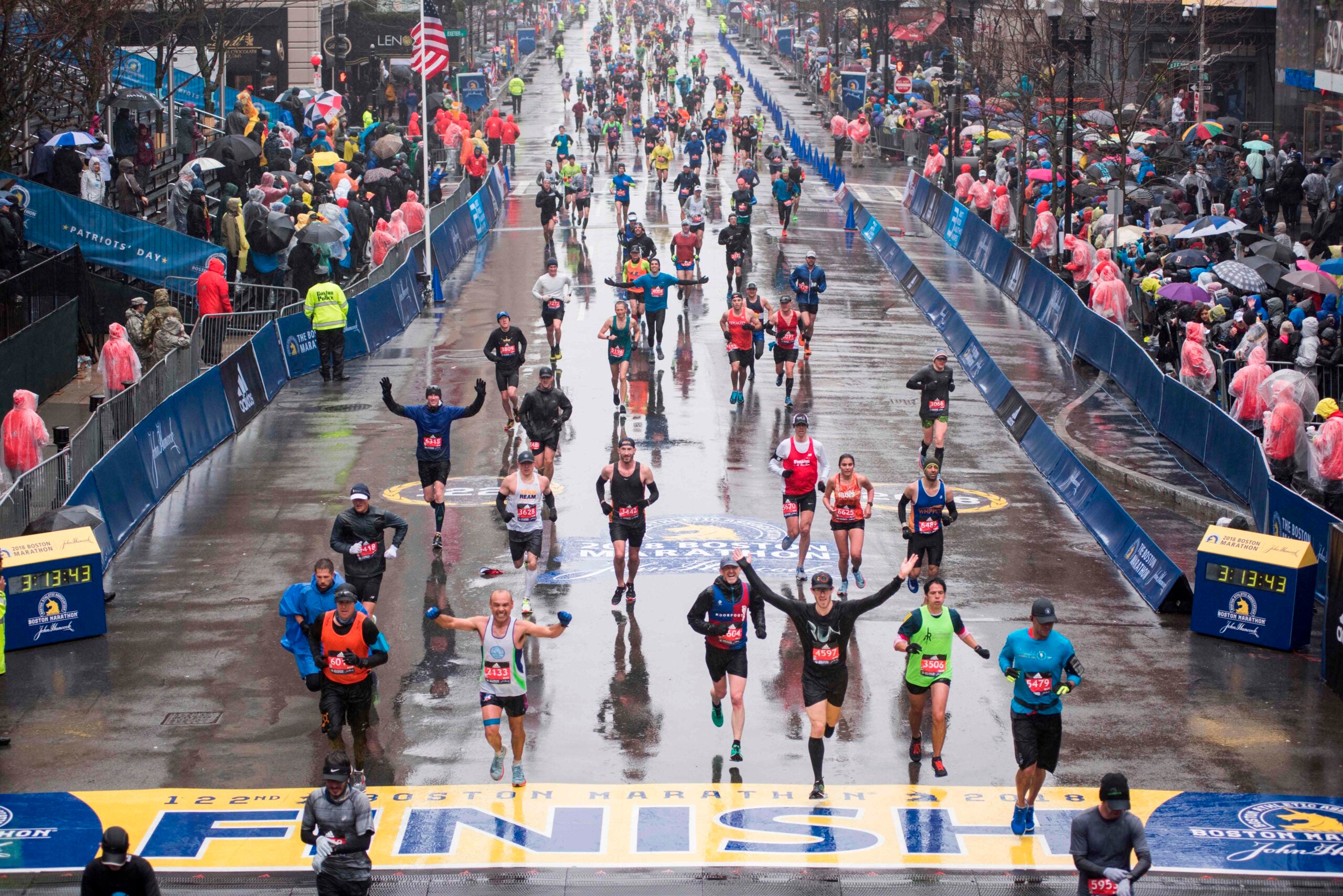 Runners come to the finish line of the 122nd Boston Marathon.