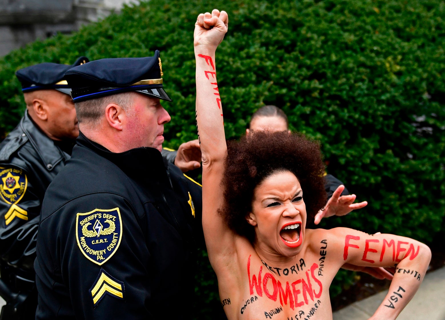 Topless protester gets close to Bill Cosby as retrial begins