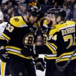 Boston Bruins defenseman Zdeno Chara (33), right wing David Pastrnak and left wing Jake DeBrusk (74) celebrate Pastrnak's goal during the second period of an NHL hockey game against the Pittsburgh Penguins on Thursday, March 1, 2018, in Boston. (AP Photo/Elise Amendola)