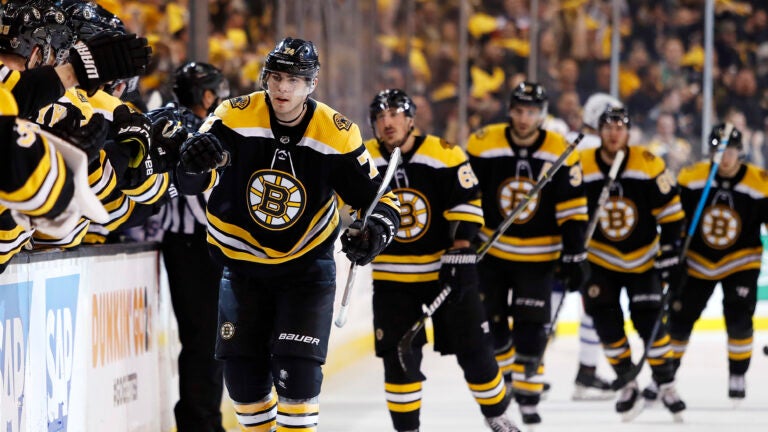 Boston Bruins' Jake DeBrusk leads teammates back to the bench after scoring against the Toronto Maple Leafs during the first period of Game 2 of an NHL hockey first-round playoff series in Boston, Saturday, April 14, 2018. (AP Photo/Winslow Townson)