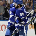 Tampa Bay Lightning right wing Nikita Kucherov (86) hugs defenseman Anton Stralman (6) after his goal against the New Jersey Devils during the third period of Game 5 of an NHL first-round hockey playoff series Saturday, April 21, 2018, in Tampa, Fla. (AP Photo/Chris O'Meara)