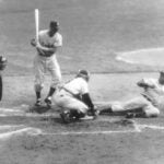 Brooklyn Dodger third baseman Jackie Robinson steals home, beating the tag of New York Yankees catcher Yogi Berra in the eighth inning of the opening game of the World Series at Yankee Stadium in New York, Sept. 28, 1955.