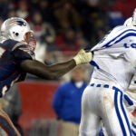 Patriots defensive lineman Jarvis Green (97,left), has Colts' quarterback Peyton Manning .