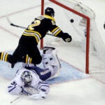 Boston Bruins center Sean Kuraly (52) scores against Toronto Maple Leafs goaltender Frederik Andersen (31) during the third period of Game 1 of an NHL hockey first-round playoff series Thursday, April 12, 2018, in Boston. (AP Photo/Elise Amendola)