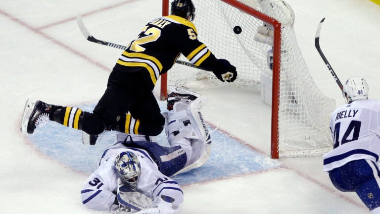 Boston Bruins center Sean Kuraly (52) scores against Toronto Maple Leafs goaltender Frederik Andersen (31) during the third period of Game 1 of an NHL hockey first-round playoff series Thursday, April 12, 2018, in Boston. (AP Photo/Elise Amendola)