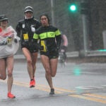 Wellesley, Ma., 04/16/18, The elite women runners make their way through a downpour in Wellesley. Wellesley College students braved the bad weather to cheer on the Boston Marathon runners.