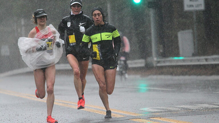 Wellesley, Ma., 04/16/18, The elite women runners make their way through a downpour in Wellesley. Wellesley College students braved the bad weather to cheer on the Boston Marathon runners.