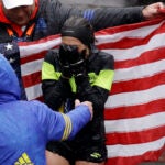 Desiree Linden, of Washington, Mich., celebrates after winning the women's division of the 122nd Boston Marathon.