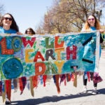 People marching in the 2017 Lowell Earth Day Parade.