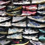 The tower of sneakers featured in "A Long-Distance Relationship: The 26.2 Mile Journey" at the Attleboro Arts Museum.