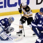 Bruins left wing Brad Marchand is unable to get a clean shot off on Tampa Bay Lightning goaltender Andrei Vasilevskiy late in the third period.