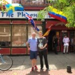 Kevin and Oisín Treanor standing with their World Cup soccer ball in front of the Phoenix Landing in Central Square.