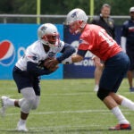 James White takes a handoff from Tom Brady during Patriots minicamp in June, 2018.