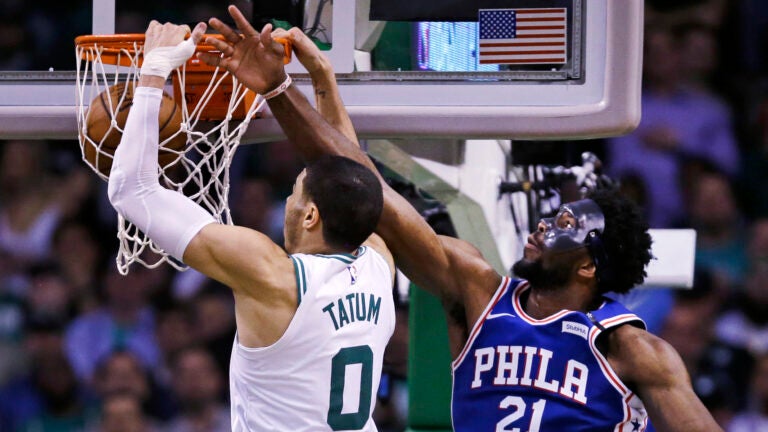 Jayson Tatum dunks on Joel Embiid during the 2018 playoffs.