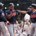 Albert Belle is congratulated by Omar Vizquel and Kenny Lofton after hitting a grand slam on Aug. 28, 1996.