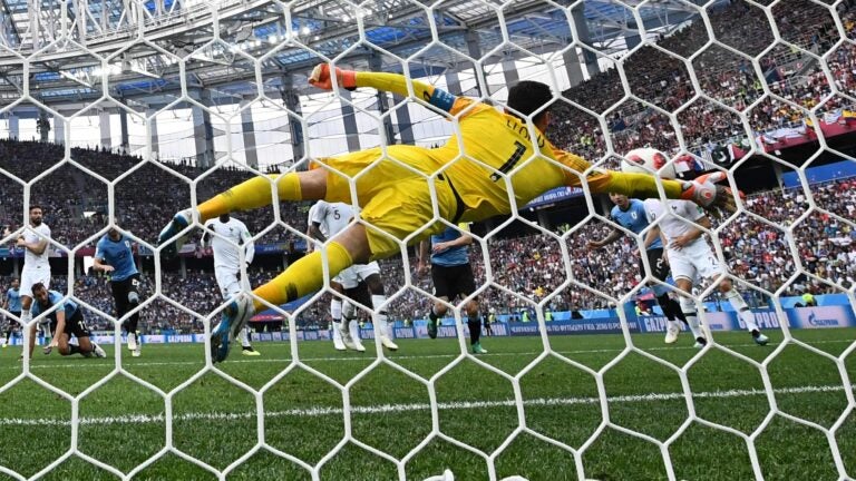 France's goalkeeper Hugo Lloris dives to make a save during the 2018 World Cup quarterfinals against Uruguay.