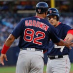 Boston Red Sox's Steve Pearce, right, is congratulated by first base coach Tom Goodwin (82) after hitting a single against the New York Yankees during the fourth inning of a baseball gam Friday, June 29, 2018, in New York. (AP Photo/Julie Jacobson)