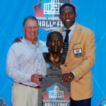 New England Patriots coach Bill Belichick, left, joins former Patriots wide receiver Randy Moss with his Pro Football Hall of Fame bust for a photo.
