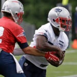 Tom Brady hands off to Sony Michel at Patriots minicamp.