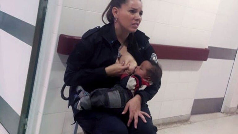 cop breastfeeds baby